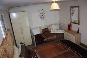 A bed or beds in a room at Robertsbridge Retreat At Cornhill Luxury Self Catering Apartments 