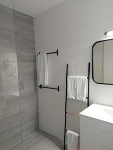 a bathroom with a shower and a sink and a mirror at Quinta do Lago Golf, Sea & Sun in Quinta do Lago