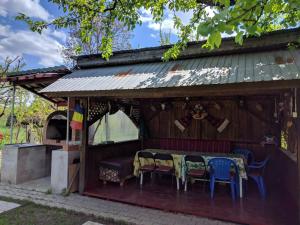 a house with a table and chairs in it at Cazare Adela in Horezu
