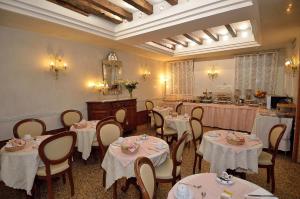 a dining room with tables and chairs and a salon at Hotel Da Bruno in Venice
