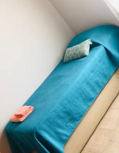 a bed with blue sheets and a pillow on it at ZR Playa Union in Playa Unión