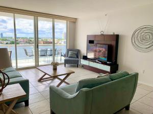 a living room with a couch and a flat screen tv at Beautiful Miami Place in Miami Beach