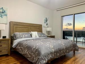 a bedroom with a bed and a large window at Beautiful Miami Place in Miami Beach