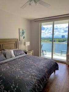 a bedroom with a bed and a view of the water at Beautiful Miami Place in Miami Beach