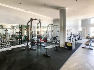 a gym with a lot of equipment in a room at Splice Apartments in Johannesburg