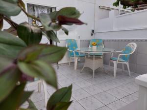 a table and chairs sitting on a patio at Jacuzzi House Sunflower in Costa Del Silencio