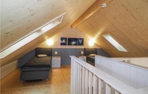 a attic room with a bed and a staircase at Ferienhaus 3 Wolfschlucht in Gondenbrett