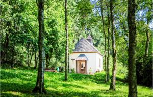 a small white chapel in the middle of a forest at Ferienhaus 3 Wolfschlucht in Gondenbrett