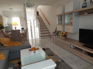 a living room with a couch and a table at Jacuzzi House Sunflower in Costa Del Silencio