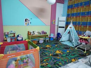 a childs bedroom with a play room with a tent at Familia Fantastiko - Family Hotel in Kiten