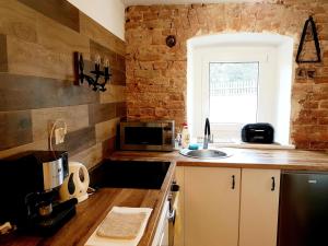 a kitchen with a sink and a microwave at Szklarka 21 in Bystrzyca Kłodzka