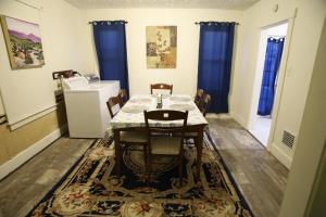 a dining room with a table and chairs on a rug at 3 bedroom one bathroom townhouse - 20B Elm street Charlton Heights WV 25040 in Glen Ferris