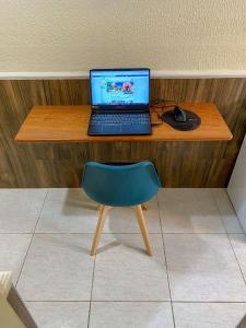 a desk with a laptop and a mouse and a chair at Refúgio Pousada Fortaleza in Fortaleza +167 photos