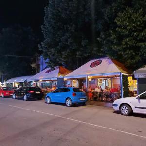 a group of cars parked in front of tents at Apartman u centru 1 in Šid