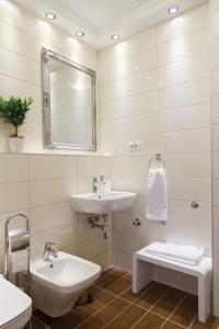 a white bathroom with a sink and a mirror at Apartment Jovanova in Belgrade