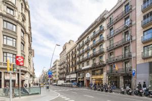 a city street with buildings and motorcycles parked on the street at Chic & Basic Lemon Boutique Hotel in Barcelona
