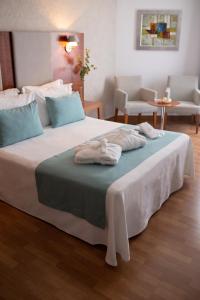 Postel nebo postele na pokoji v ubytování Hotel El Trebol