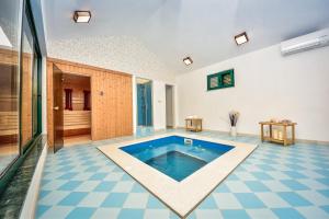 a swimming pool in the middle of a room at in olive garden in Starigrad-Paklenica