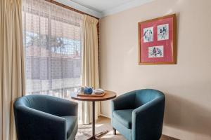 a living room filled with furniture and a window at Bomaderry Motor Inn in Nowra