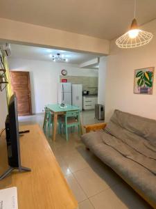 a living room with a couch and a table at Andino Apartaments Rental Rivadavia in San Juan