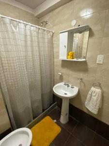 a bathroom with a sink and a toilet and a shower at Andino Apartaments Rental Rivadavia in San Juan