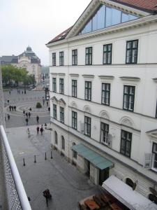 a large white building with people walking on a street at Apartmán Old centre - Rybárska brána in Bratislava