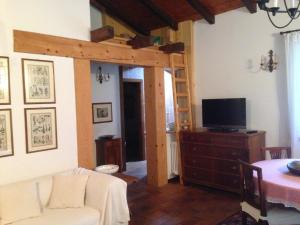 a living room with a loft bed and a tv at Casa Aldo Lago di Ledro in Ledro