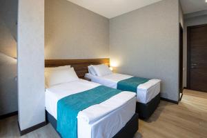 Una cama o camas en una habitación de Hotel GENI Kazbegi