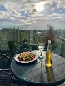 una mesa con un plato de comida y una copa de vino en Seaview Apt in Buncrana with balcony, en Buncrana
