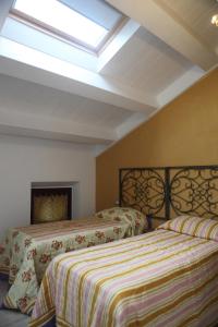 a bedroom with two beds and a skylight at DormidaNoi B&B in Civitanova Marche