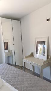 a bedroom with a bed and a desk and a mirror at Villa Queen in Zadar