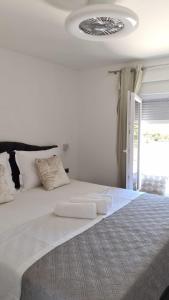 a bedroom with a bed with two white towels on it at Villa Queen in Zadar