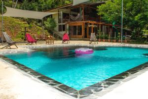 a swimming pool in the middle of a resort at Bamboo River House and Hotel in Dominical