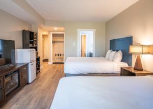 a hotel room with two beds and a flat screen tv at Fresh and Modern Superior Deluxe Top Floor Hotel Room Walk to Skiing Restaurants Shops in Park City