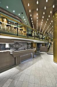 a lobby with escalators in a building at Hotel Atlantico Star in Rio de Janeiro