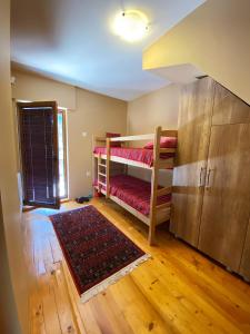 a room with two bunk beds and a rug at Brezovica Luxury Villa in Brezovicë +23 photos