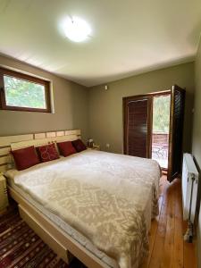 a bedroom with a large bed and a window at Brezovica Luxury Villa in Brezovica +23 photos