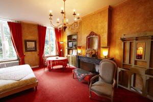 a bedroom with a bed and a mirror and a table at Home Fleuri Guesthouse in Bruges