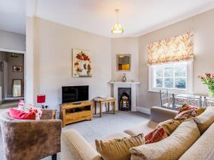 a living room with two couches and a fireplace at Riverside in Craven Arms