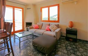 a living room with a couch and a table at Nice Home In Sant Cebria De Vallalt in Sant Cebrià de Vallalta
