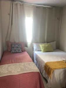 Ένα ή περισσότερα κρεβάτια σε δωμάτιο στο Casa para Temporada Lençóis Ville +84 φωτογραφίες
