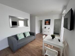 a living room with a couch and a table at Modern Luxury Villa in Poris de Abona