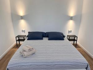 a bedroom with a large bed with towels on it at Modern Luxury Villa in Poris de Abona