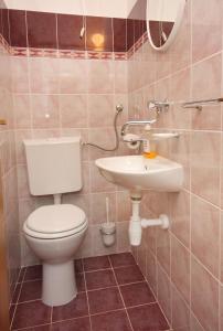 a bathroom with a toilet and a sink at Apartments by the sea Postira, Brac - 5152 in Postira