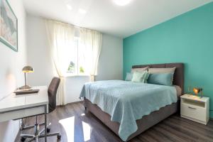 a blue bedroom with a bed and a window at New Luxury Bella Apartment in Split