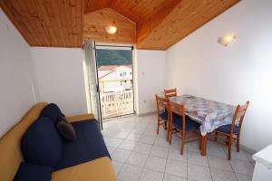 a living room with a table and a couch at Apartment Grebastica 4867a in Grebaštica