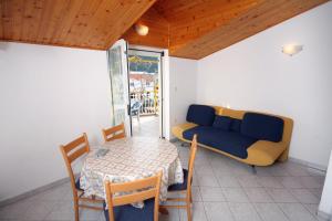 a room with a table and a couch and a table and chair at Apartments with a parking space Grebastica, Sibenik - 4867 in Grebaštica
