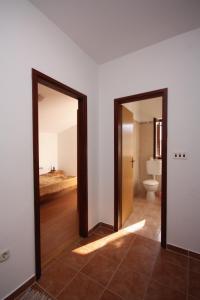 two doors in a room with a toilet at Apartments with parking space Jezera, Murter - 5109 in Jezera