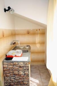 a kitchen with a stone counter with a sink at Apartments by the sea Jezera, Murter - 5063 in Jezera