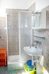 a bathroom with a shower and a sink at Apartments by the sea Jezera, Murter - 5063 in Jezera